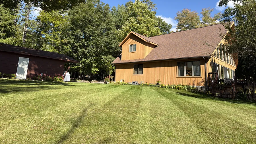 Striped lawn in front of a cedar house on Hubbard Lake