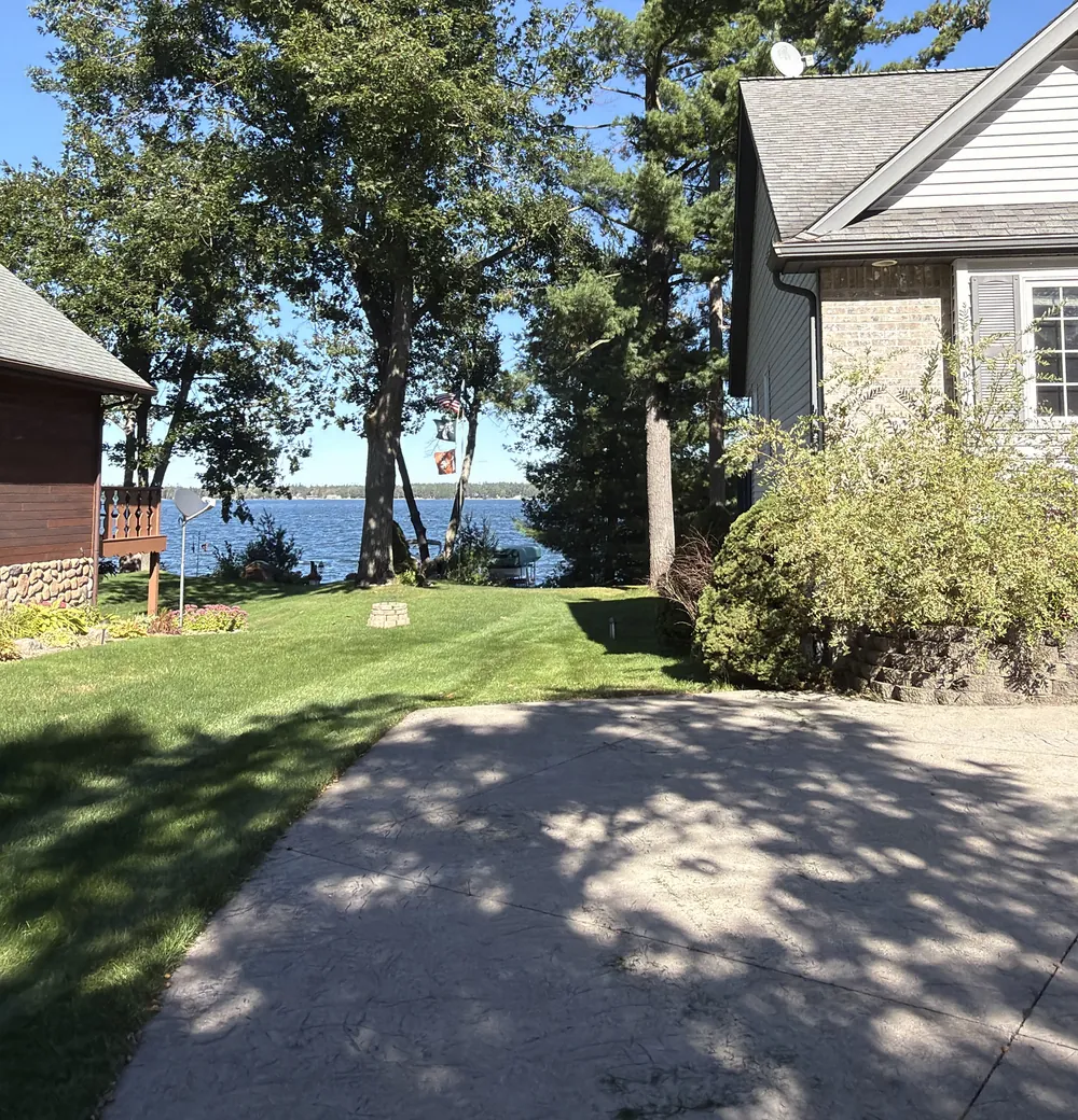 A tidy lawn and driveway beside a lakeside home in Lewiston