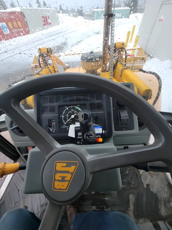 Driver's view from inside a loader cab in the snow