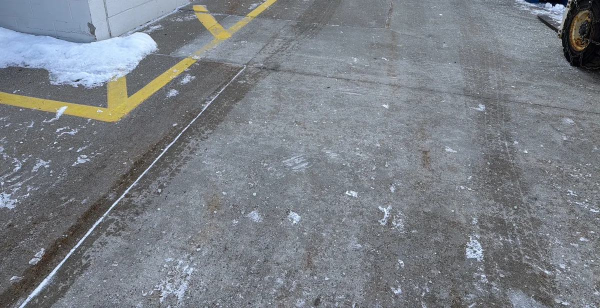 A cleared lot lane beside a building after plowing