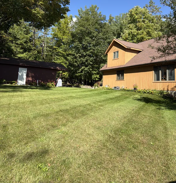 Crisp mowing stripes leading up to a lake house