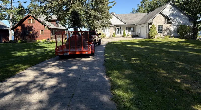 Mowed lawn and driveway with the crew trailer parked at a Lewiston home